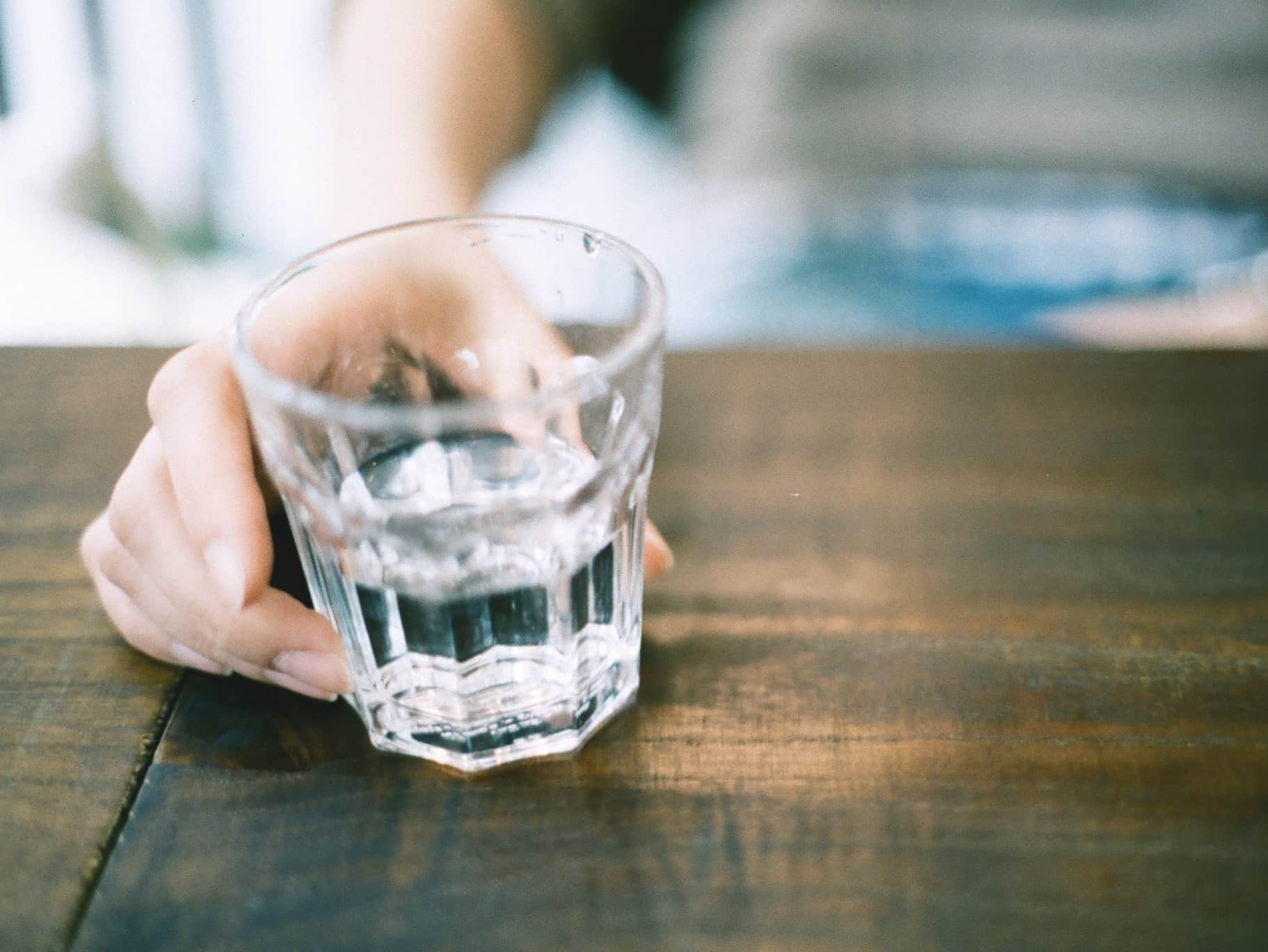 person holding glass of water